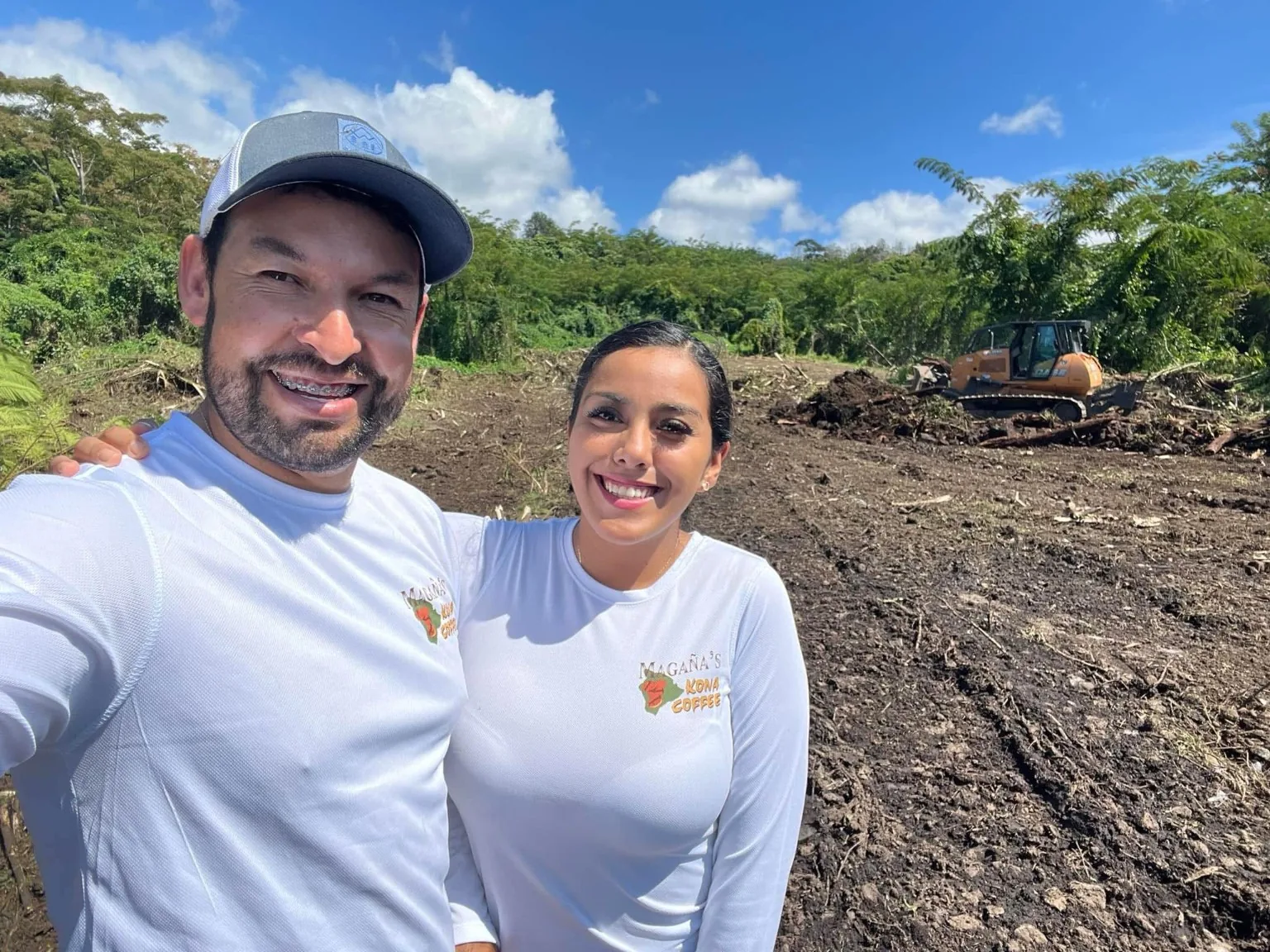 David and family together on the Kona farm with the land visible behind them
